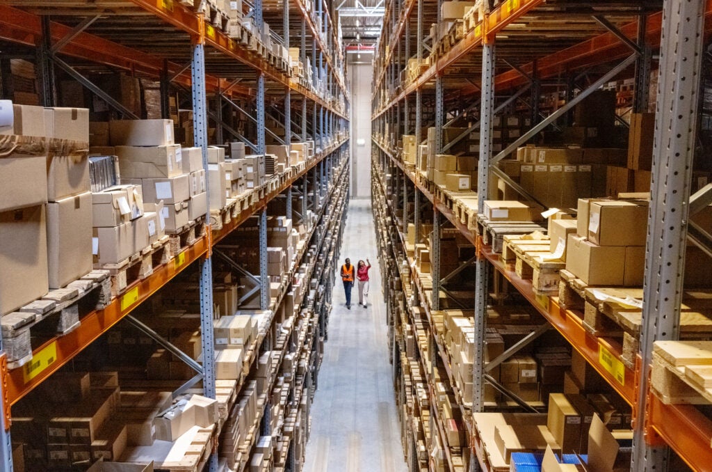 Warehouse overview with two people walking through