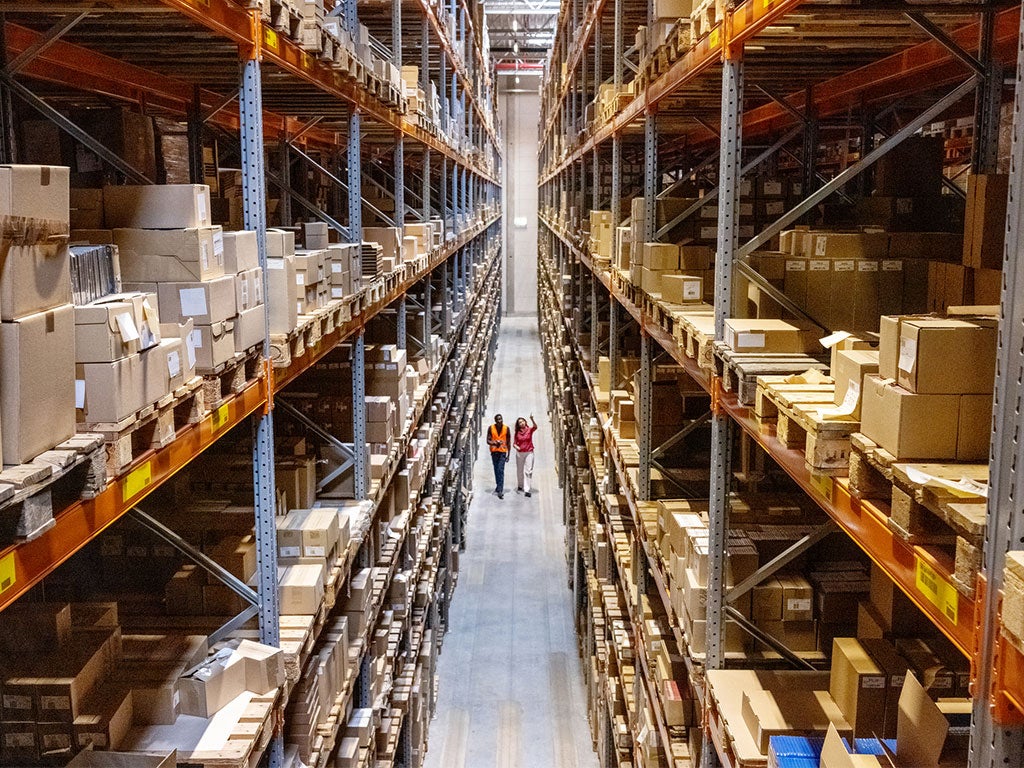 Warehouse overview with people walking through