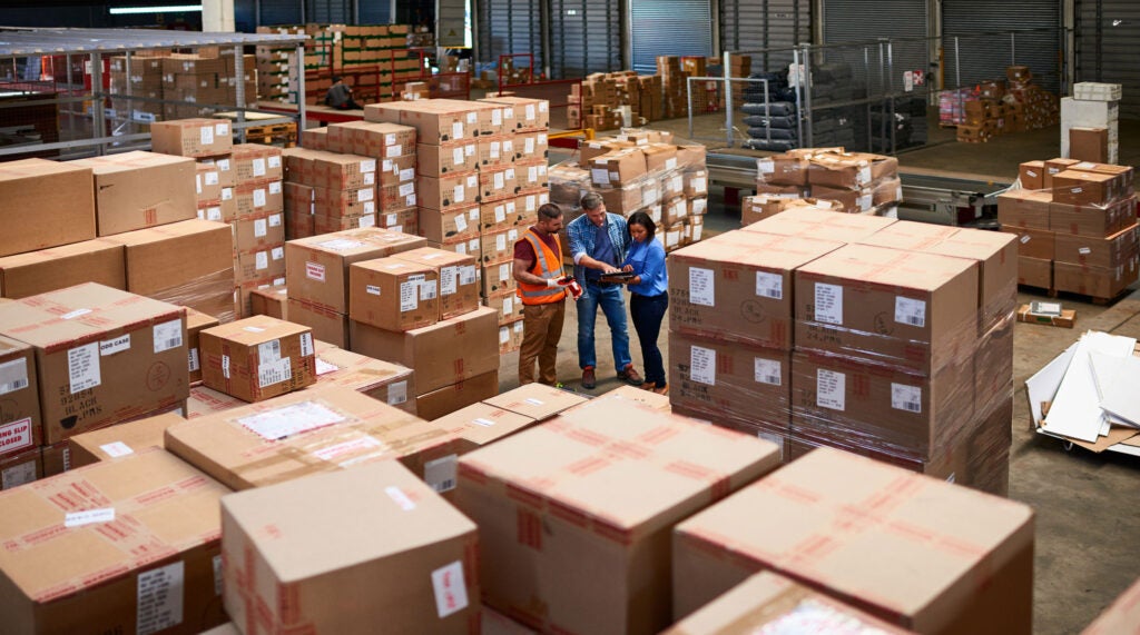 People at work in a large warehouse