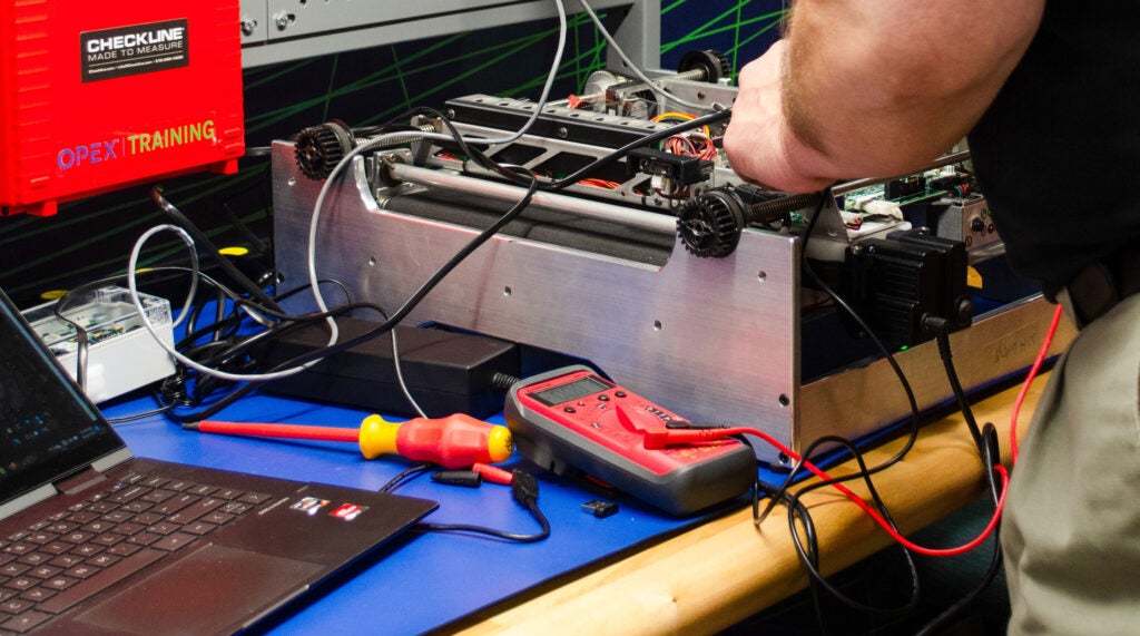 Person completing maintenance on machine