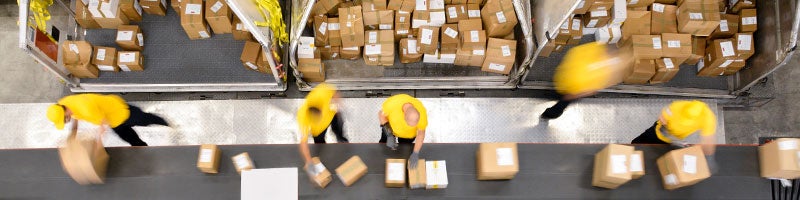 Workers sorting items on a conveyor belt