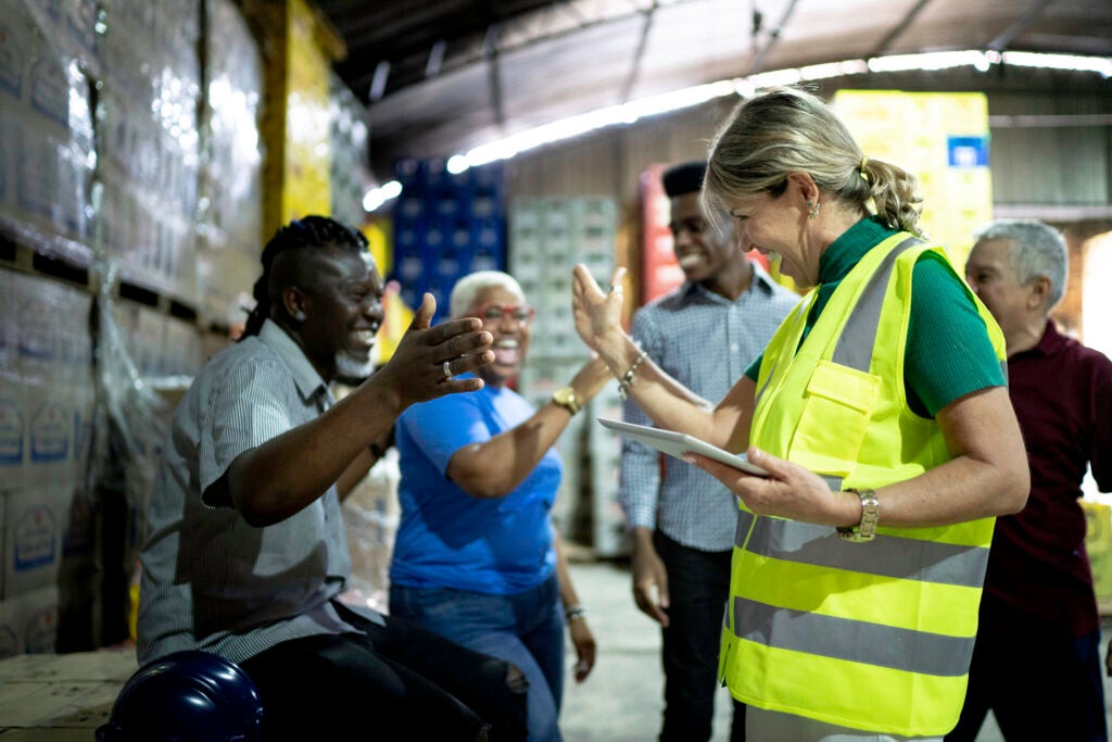 Workers celebrating and high fiving