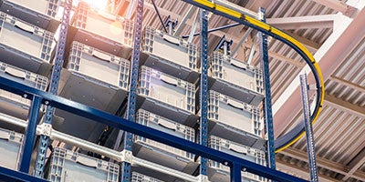 Huge distribution warehouse with high shelves and loaders